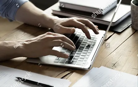 hands typing on a laptop